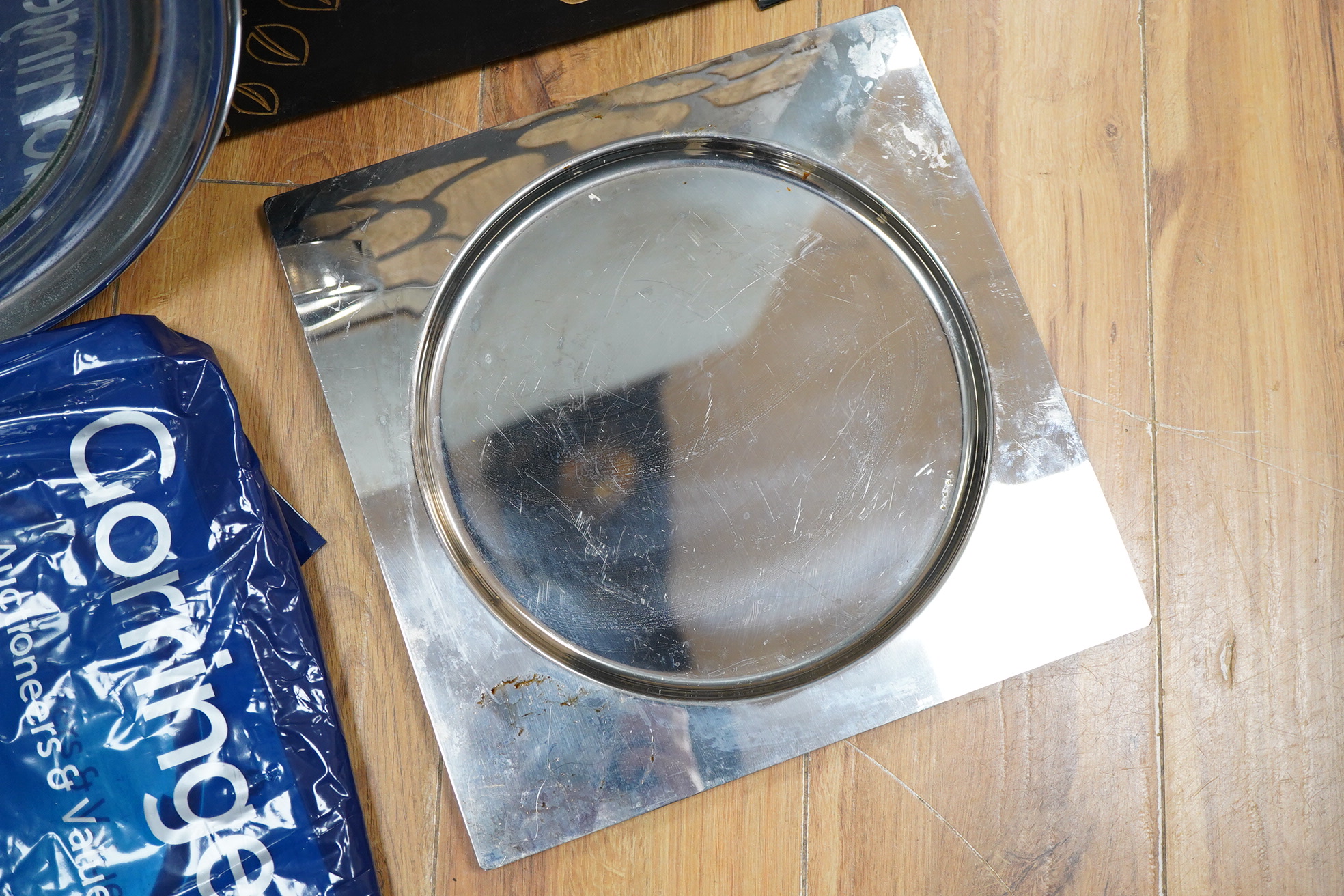 A framed botanical print, circular mirror, floral wood block and a set of metal place mats